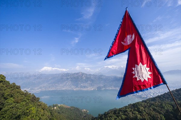 Nepali national flag waving high above the Phewa Lake and Pokhara