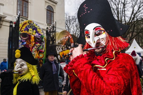 Many different groups of masked people walking through the streets of Basel