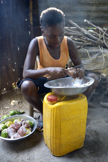 Young woman cooking in a simple kitchen