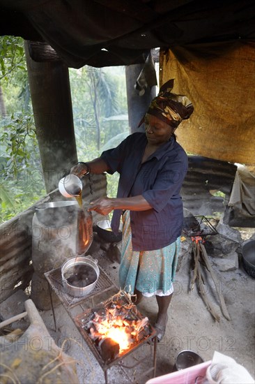 Woman brewing coffee in a simple kitchen