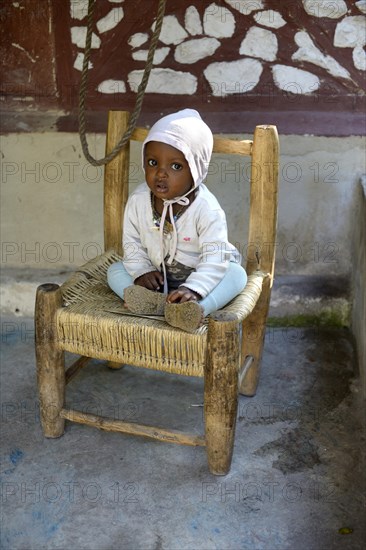 Toddler sitting on a chair