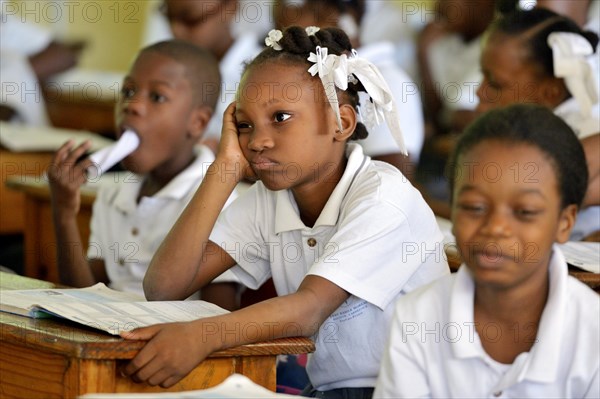 Schoolgirl with sullen facial expression during class