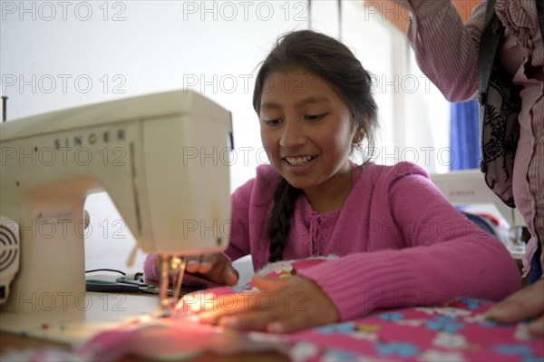 Girl using sewing machine