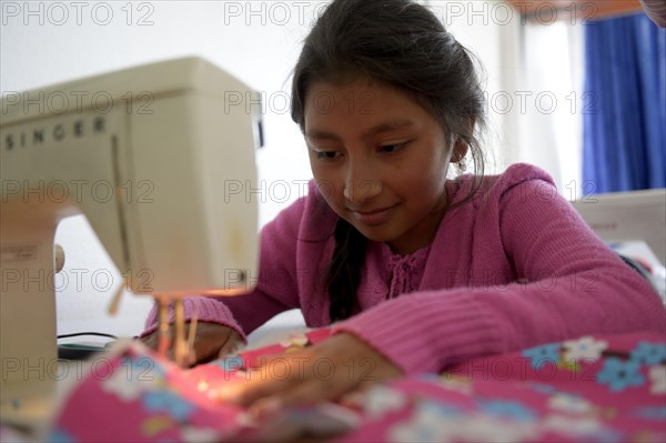 Girl using sewing machine