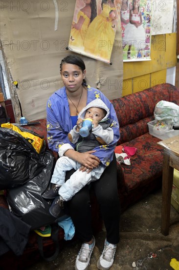 Young woman with baby in a makeshift camp for civil war refugees