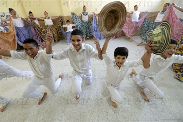 Boys taking bow with straw hats