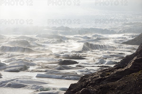 Glacial lake and glacier in fog