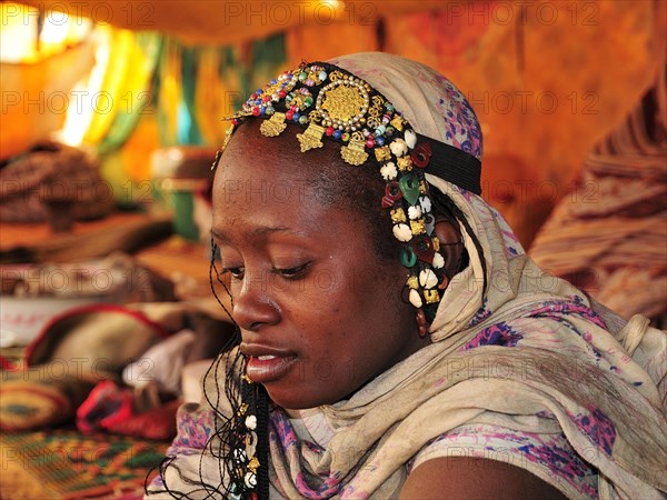 Woman with headdress in a tent