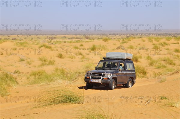 SUV with roof tent on the road in the desert