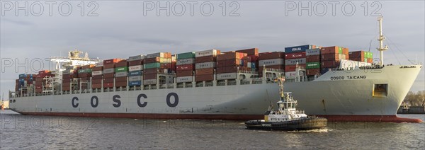 Container ship with tug on the Elbe