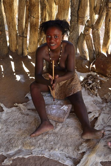 Damara woman making jewellery