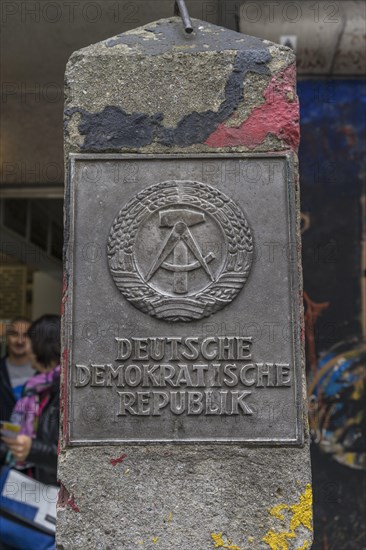 Old concrete pillar of the Inner German border with sign Deutsche Demokratische Republik or German Democratic Republic