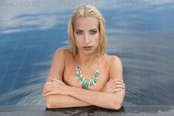 Young woman posing in pool
