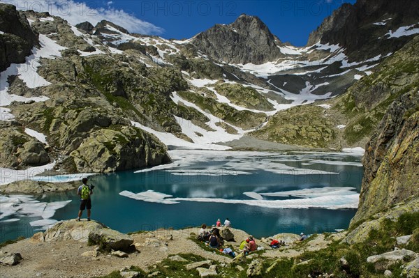 Tourists at Lac Blanc in Aiguilles Rouges National Nature Reserve