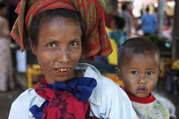 Local woman with typical headgear with child