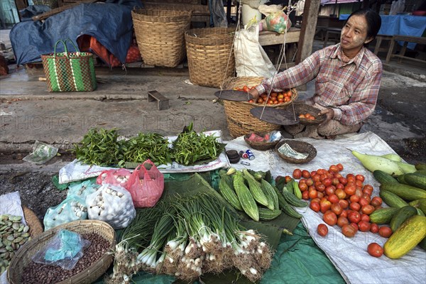 Local woman selling vegetables at the market in Nyaungshwe