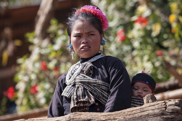 Native young woman with young child in typical clothing