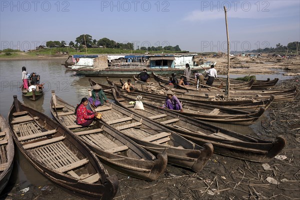 Many wooden boats at the dock in the river Irrawaddy