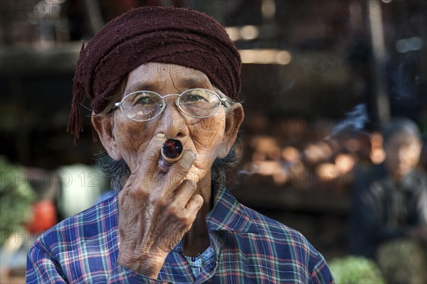 Native woman smoking a Cheeroot cigar