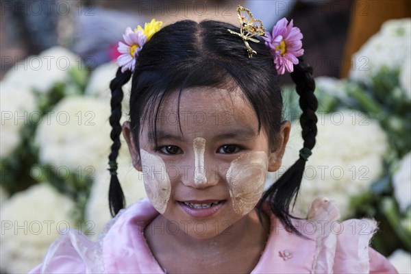 Local girl with braids and Thanka paste on her face