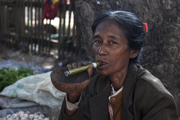Native woman smoking a Cheeroot cigar