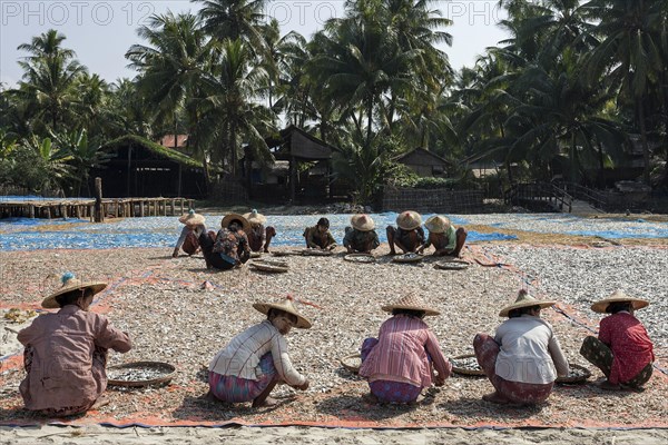 Local women wearing straw hats