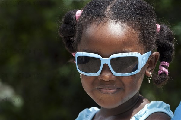 Local girl with white sunglasses and pigtails