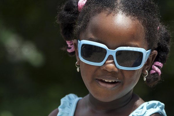 Local girl with white sunglasses and pigtails