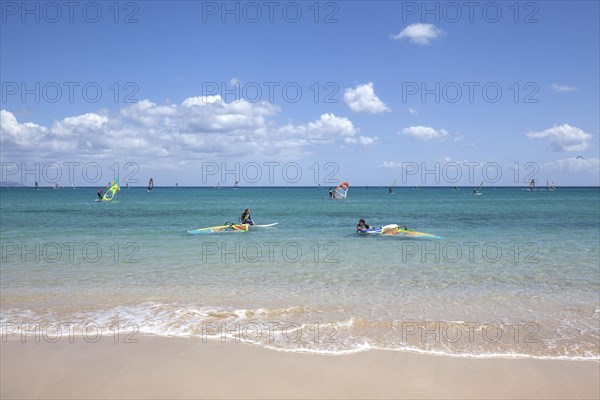 Windsurfers in the turquoise waters off the Playa Risco del Paso beach