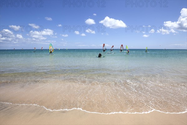 Windsurfers in the turquoise waters off the Playa Risco del Paso beach