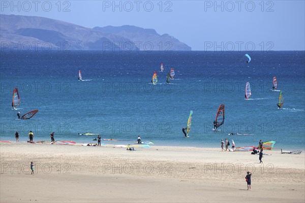 Windsurfers in the turquoise waters off the Playa Risco del Paso beach