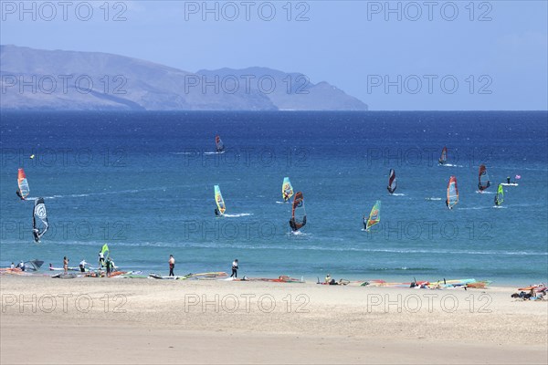 Windsurfers in the turquoise waters off the Playa Risco del Paso beach