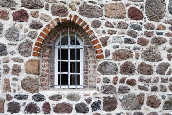 Old stone wall made of rocks and bricks