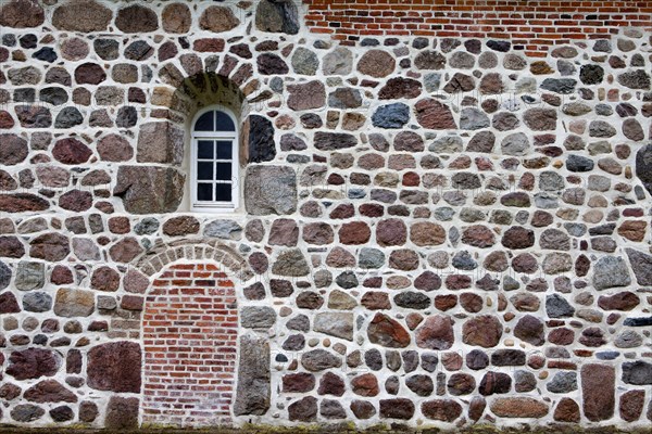 Old stone wall made of rocks and bricks