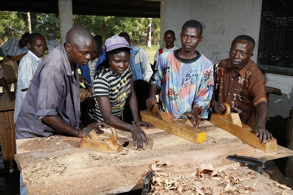 Apprentices planing wood