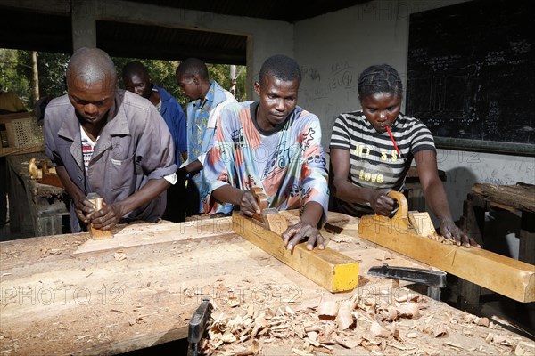 Apprentices planing wood