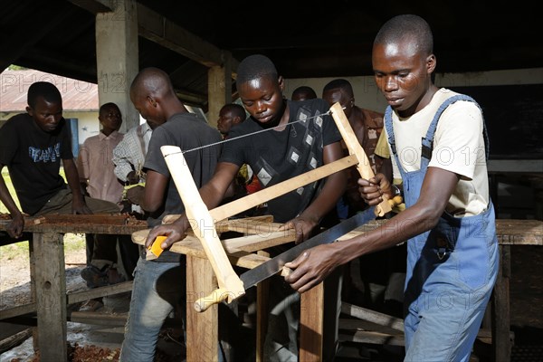 Apprentices sawing wood