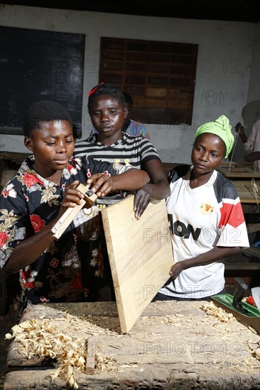 Apprentices planing wood