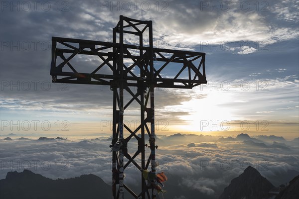 Sunrise at the summit cross of Punta Penia