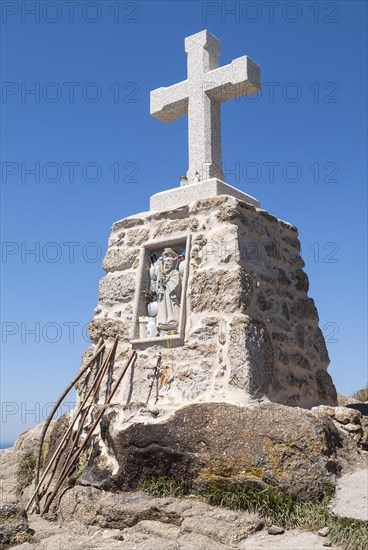 Stone cross and pilgrim sticks