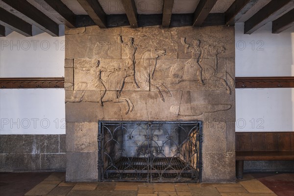 Fireplace with hunting scene relief