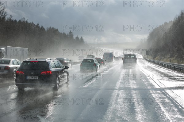 Cars overtaking in the rain