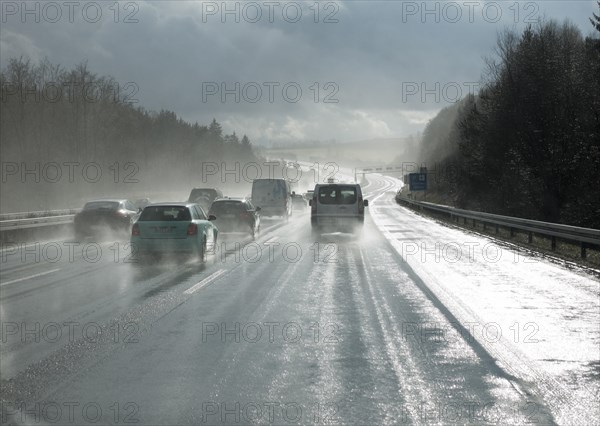 Cars overtaking in the rain