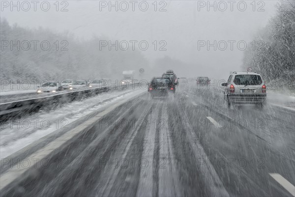 Cars with falling snow and ice