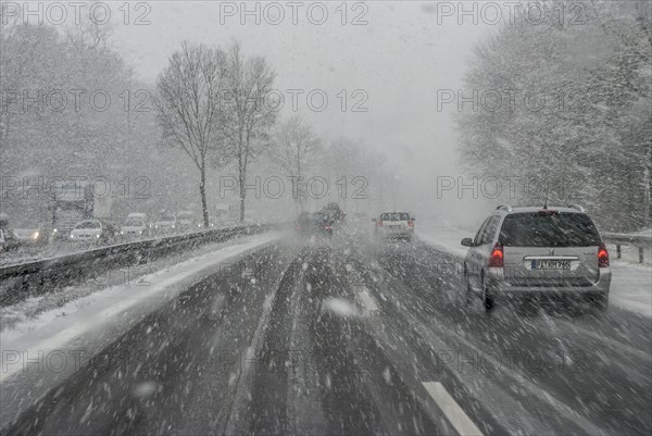 Cars with falling snow and ice