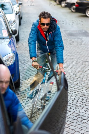 Cyclist in the city dodging a car door being opened