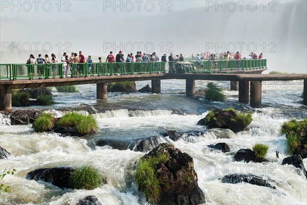 Tourists on the boardwalk to the Devil's Throat or Garganta do Diablo