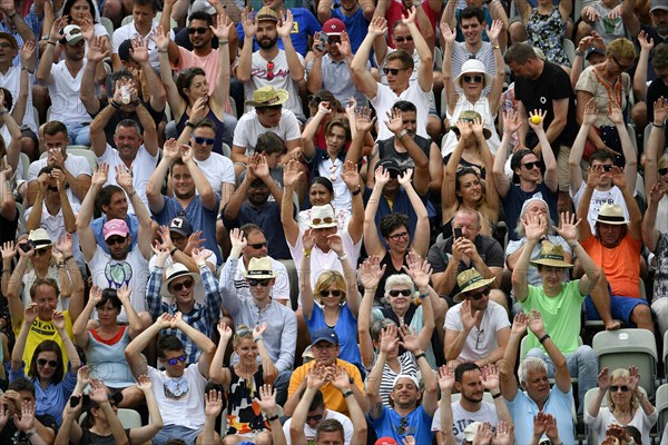 Spectators on the tribune make wave