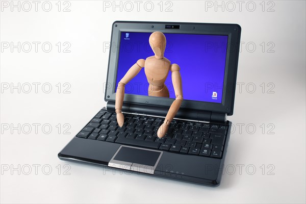 Wooden doll coming out of a laptop screen