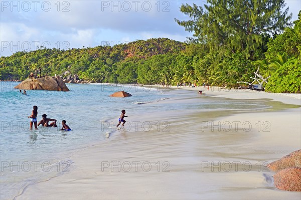 Children bathing on Anse Lazio beach